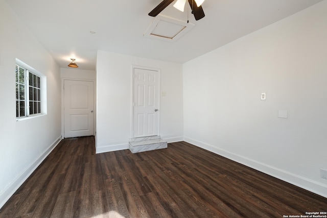 empty room with ceiling fan and dark wood-type flooring