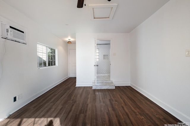 empty room featuring dark hardwood / wood-style floors and a wall mounted AC