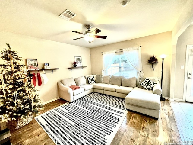 living room with hardwood / wood-style flooring and ceiling fan