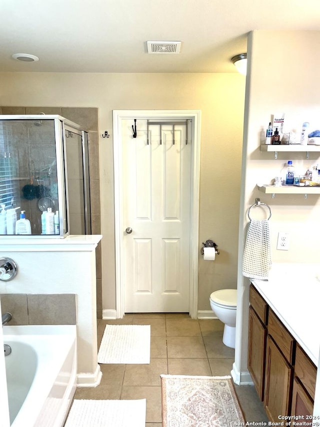 full bathroom with tile patterned floors, plus walk in shower, vanity, and toilet