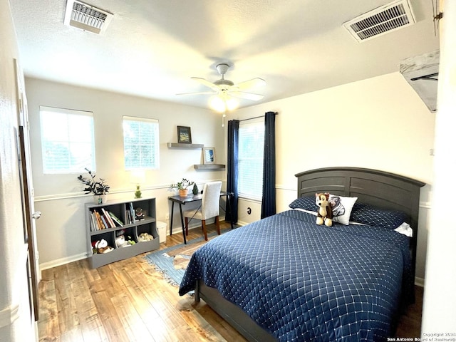 bedroom with ceiling fan and wood-type flooring