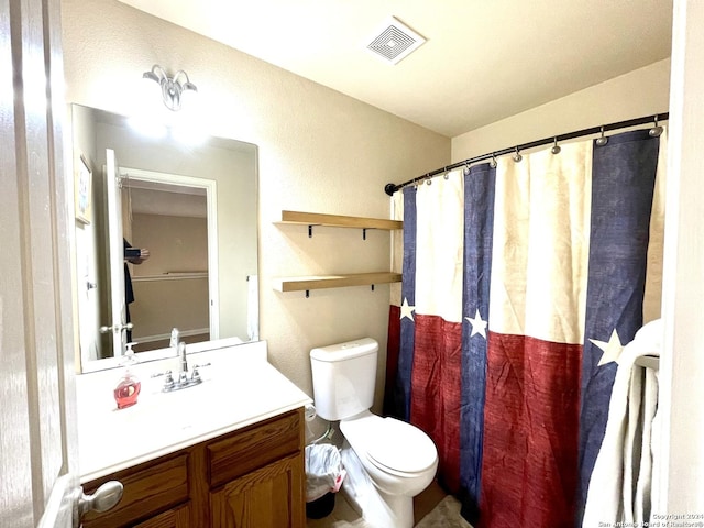 bathroom featuring vanity, curtained shower, and toilet