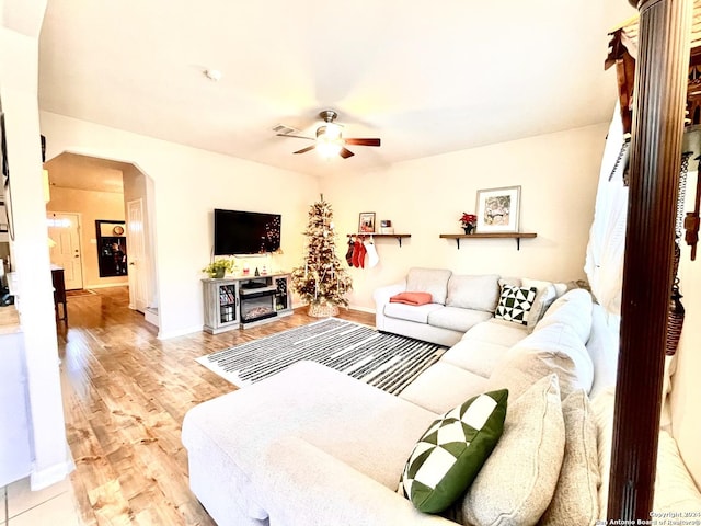 living room featuring ceiling fan and light hardwood / wood-style flooring