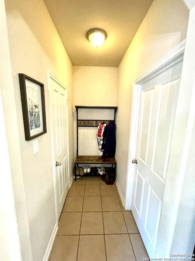 hallway featuring light tile patterned floors