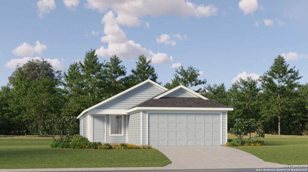 ranch-style house featuring a garage and a front yard