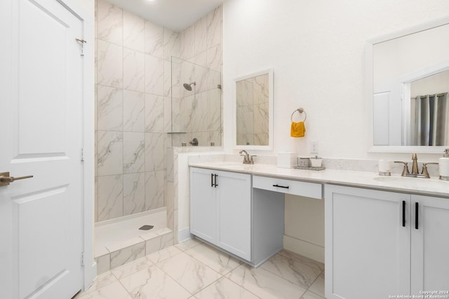 bathroom featuring a tile shower and vanity