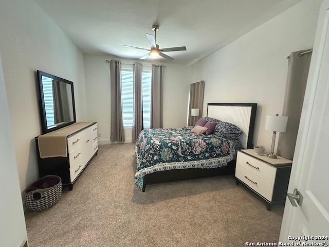 carpeted bedroom with ceiling fan