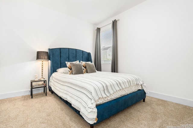 bedroom with carpet and lofted ceiling