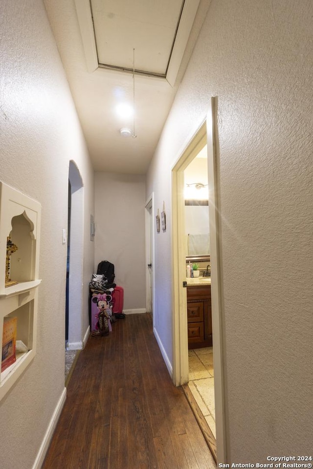 hallway featuring dark hardwood / wood-style flooring