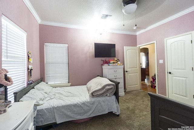 bedroom featuring a textured ceiling, light colored carpet, ceiling fan, and crown molding