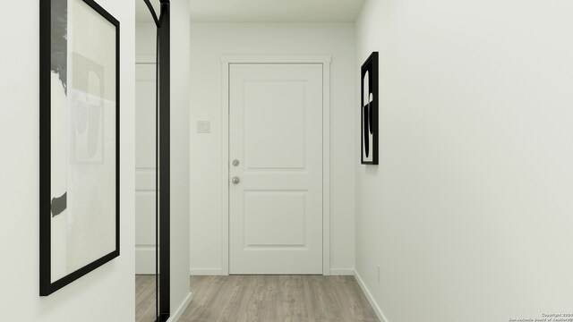 corridor with light hardwood / wood-style floors