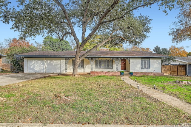 single story home with a front lawn and a garage