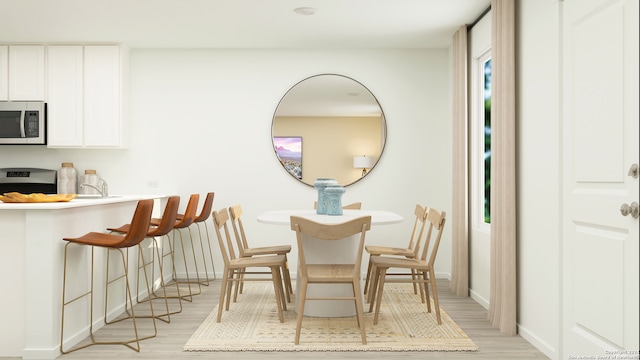 dining space with light wood-type flooring