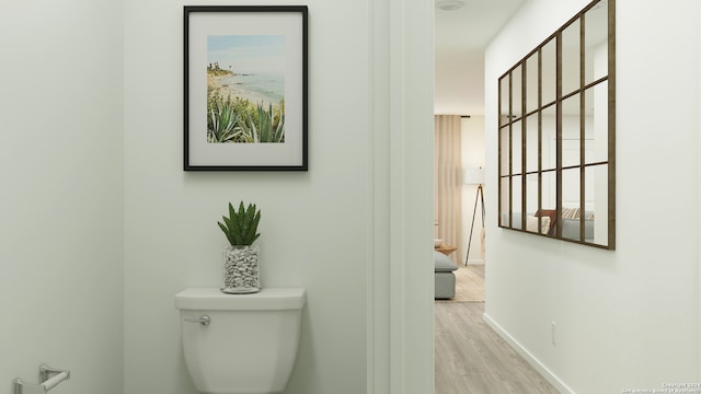 bathroom with wood-type flooring and toilet