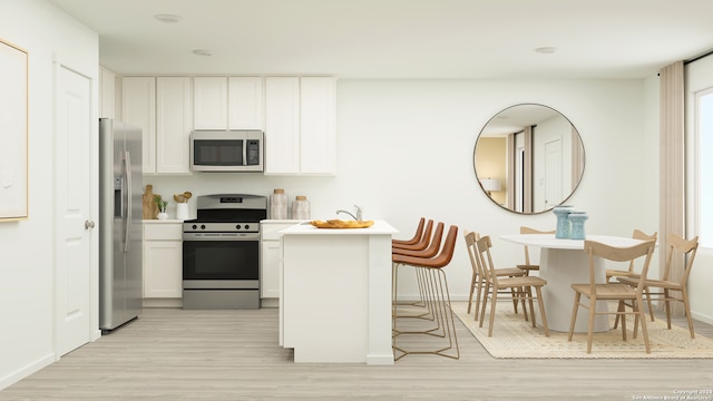 kitchen with white cabinetry, light hardwood / wood-style flooring, and stainless steel appliances