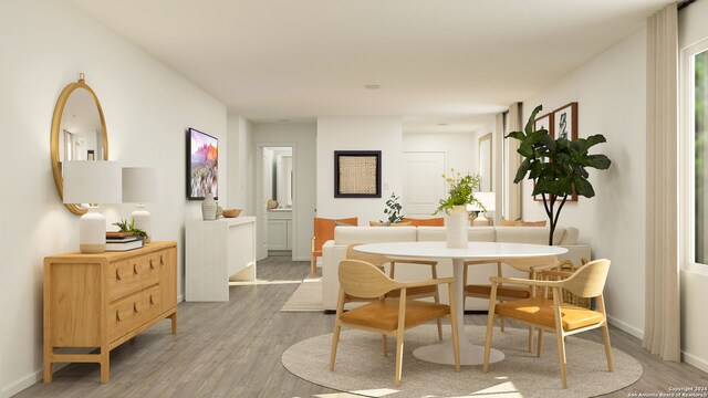 dining space with hardwood / wood-style flooring