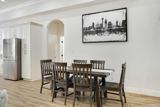 dining area featuring light hardwood / wood-style flooring and ornamental molding