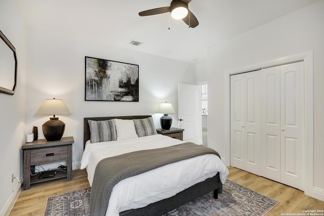 bedroom with light hardwood / wood-style floors, a closet, and ceiling fan