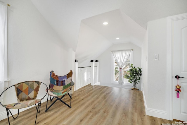 sitting room with light hardwood / wood-style floors and lofted ceiling