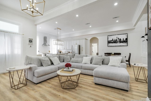 living room featuring ornamental molding and light hardwood / wood-style flooring