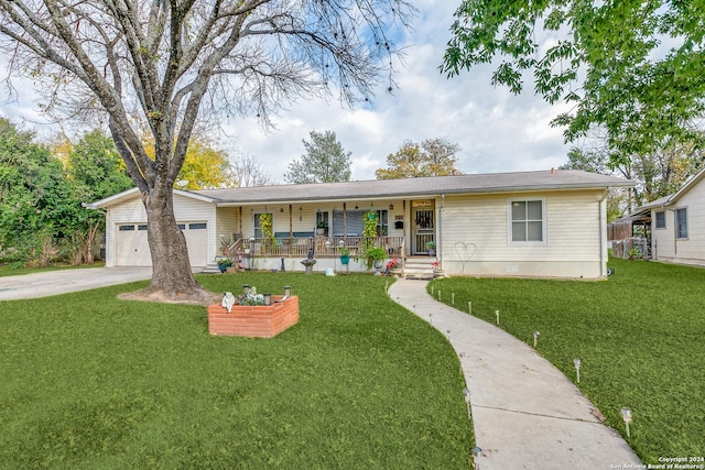 single story home with a porch, a garage, and a front lawn