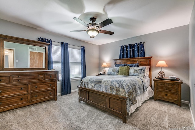 bedroom with ceiling fan and light colored carpet