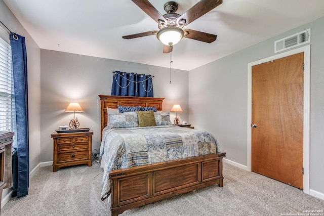 bedroom with light colored carpet and ceiling fan