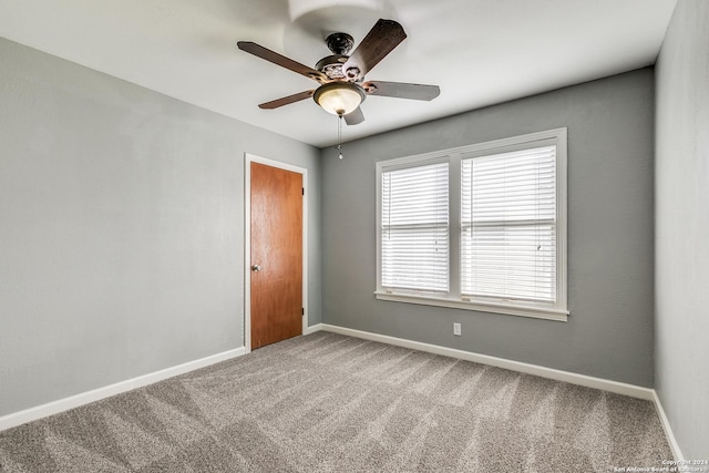 spare room featuring carpet flooring and ceiling fan