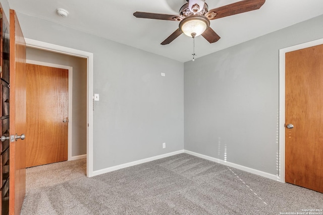 spare room featuring ceiling fan and light colored carpet