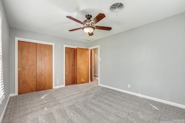 unfurnished bedroom featuring carpet flooring and ceiling fan