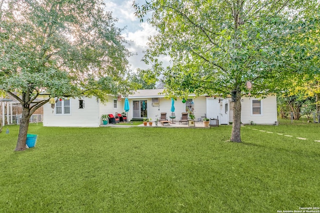 back of property featuring a yard and a patio