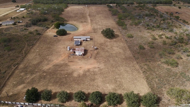 birds eye view of property featuring a water view and a rural view