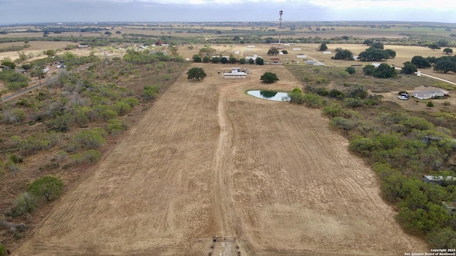 birds eye view of property with a rural view and a water view