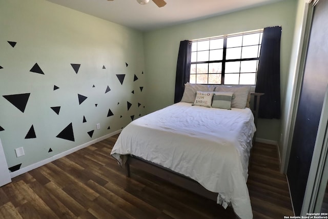 bedroom with ceiling fan and dark hardwood / wood-style floors