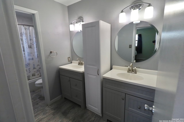 full bathroom featuring shower / tub combo, vanity, hardwood / wood-style flooring, and toilet