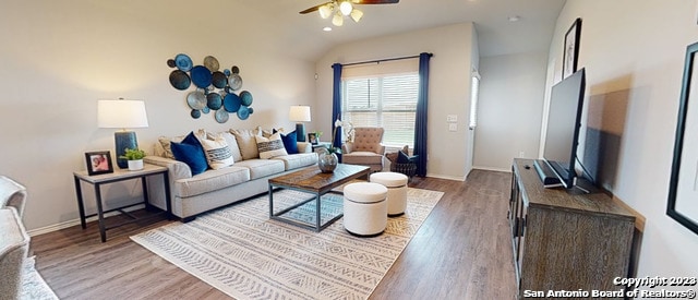 living room with ceiling fan, hardwood / wood-style floors, and lofted ceiling