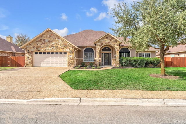 view of front of property with a front lawn and a garage