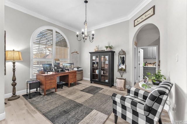 home office with crown molding, a notable chandelier, and light wood-type flooring