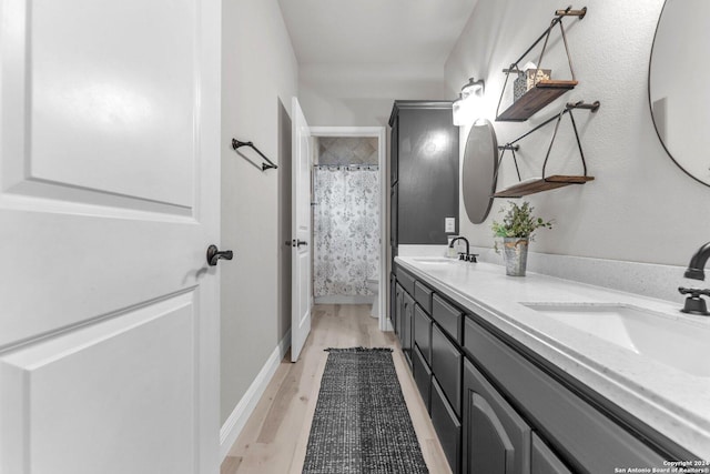 bathroom featuring vanity, wood-type flooring, and walk in shower