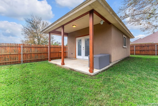 rear view of house with a yard, a patio area, french doors, and central air condition unit