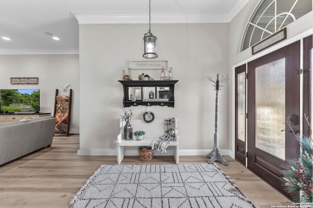 foyer entrance with light hardwood / wood-style flooring and crown molding