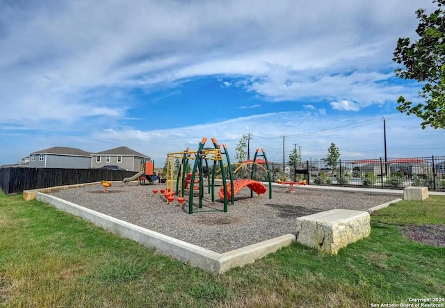 view of jungle gym featuring a lawn