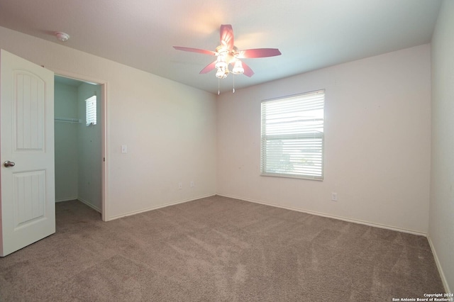 carpeted empty room with ceiling fan