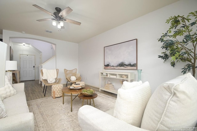 living room featuring hardwood / wood-style floors and ceiling fan