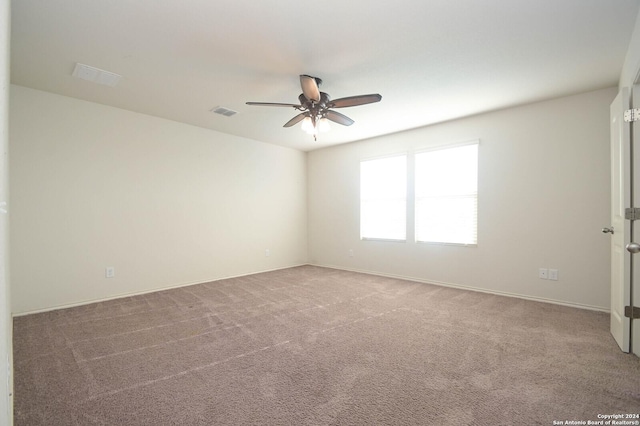 spare room with ceiling fan and carpet floors