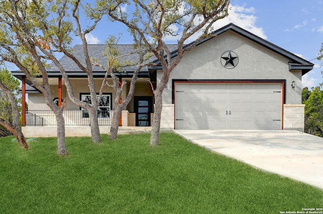 single story home featuring a porch, a garage, and a front lawn