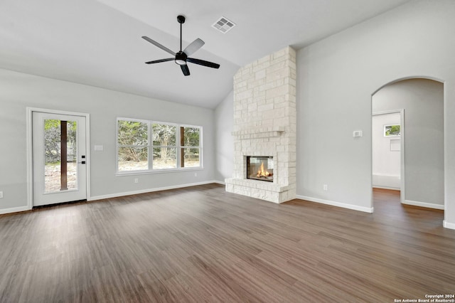 unfurnished living room with ceiling fan, a fireplace, and dark wood-type flooring