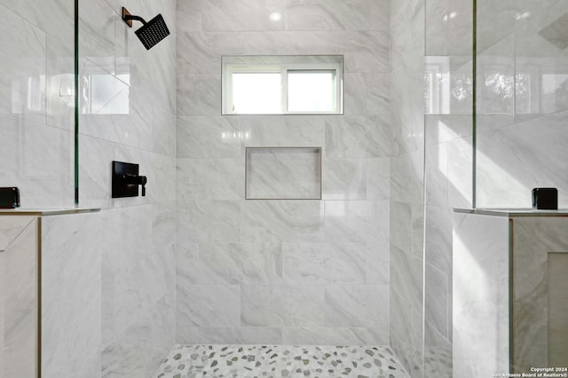 bathroom with a tile shower