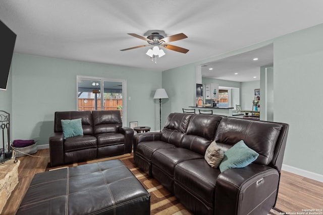 living room featuring hardwood / wood-style floors and ceiling fan