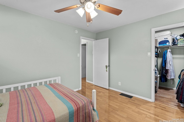 bedroom featuring ceiling fan, a closet, and light hardwood / wood-style flooring